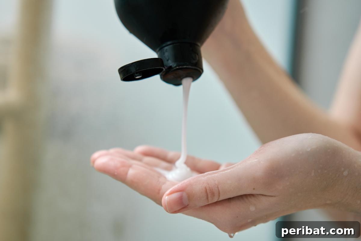 A person pouring homemade shampoo onto their palm, highlighting natural hair care and DIY beauty products.