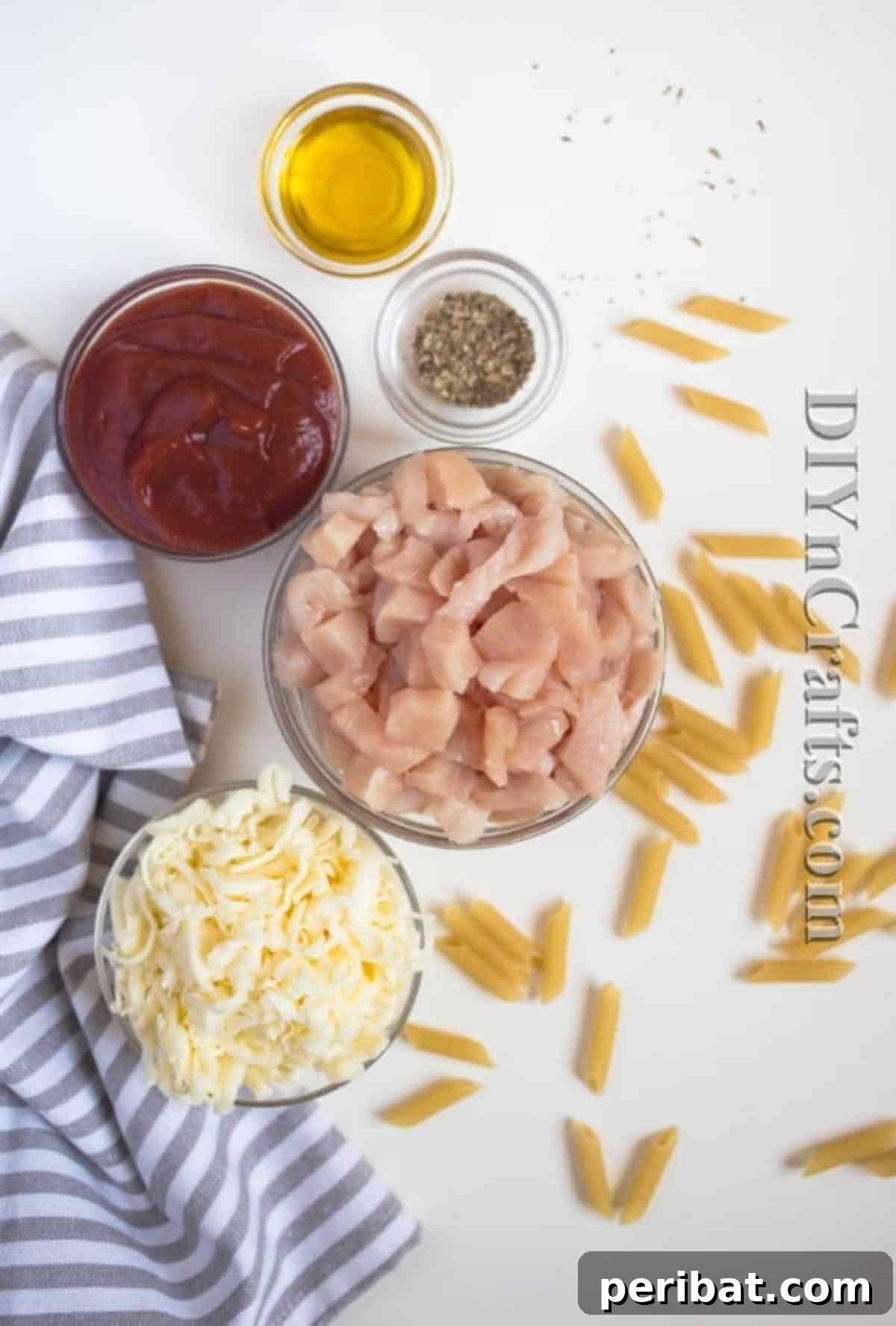 The Ultimate Easy Skillet Chicken Pasta 3 Ingredients for a one-pot chicken pasta skillet: chicken breast, pasta, tomato sauce, cheese, olive oil, oregano, and basil.