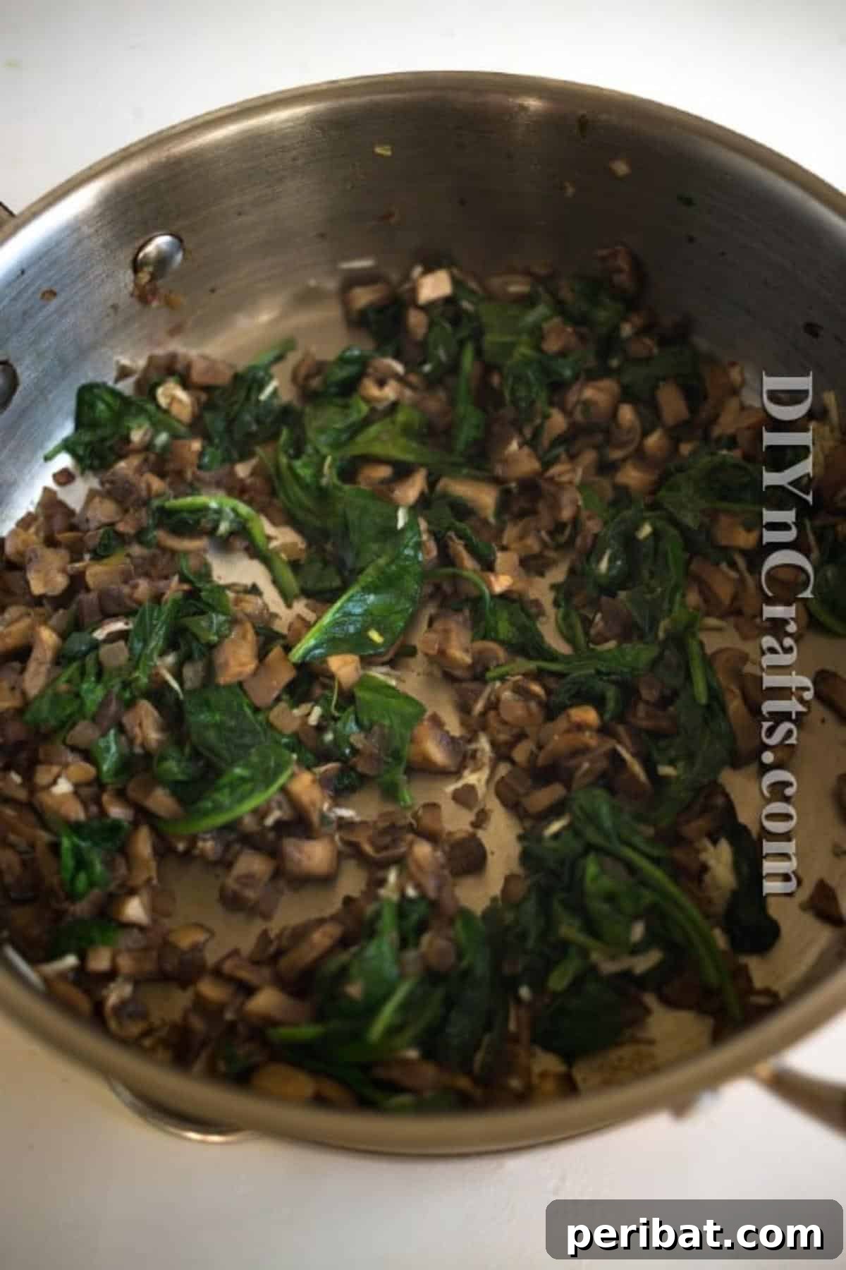 Reimagined Potato Spinach Patties A Delicious Classic 5 Sautéed cremini mushrooms, garlic, and spinach in a pan, ready to be mixed into potato base