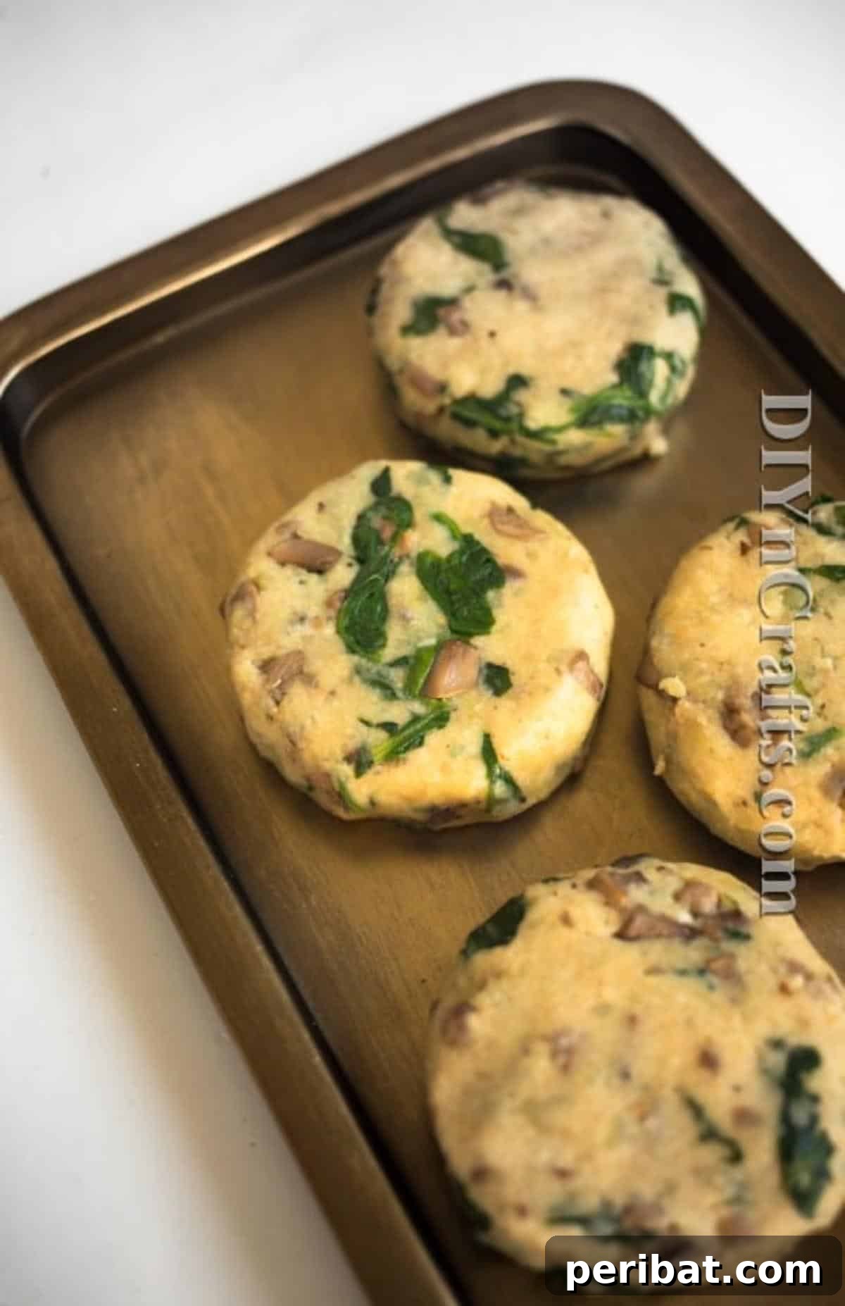 Reimagined Potato Spinach Patties A Delicious Classic 6 Hands pressing potato mixture into uniform round patty shapes before frying