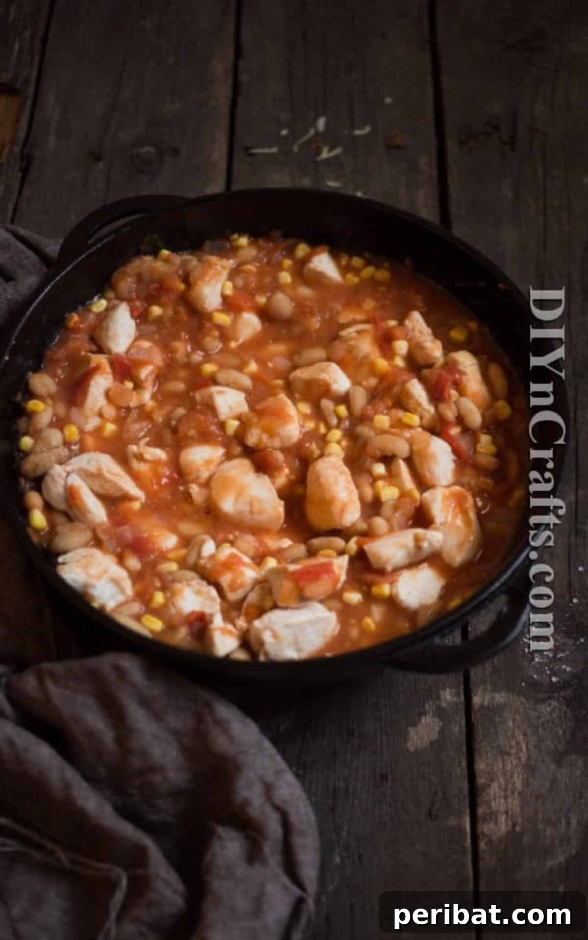 Chicken, combined with corn and white beans, gives it a great authentic Mexican flavor. A spoonful of the chicken, corn, and white bean mixture, highlighting the textures and colors.