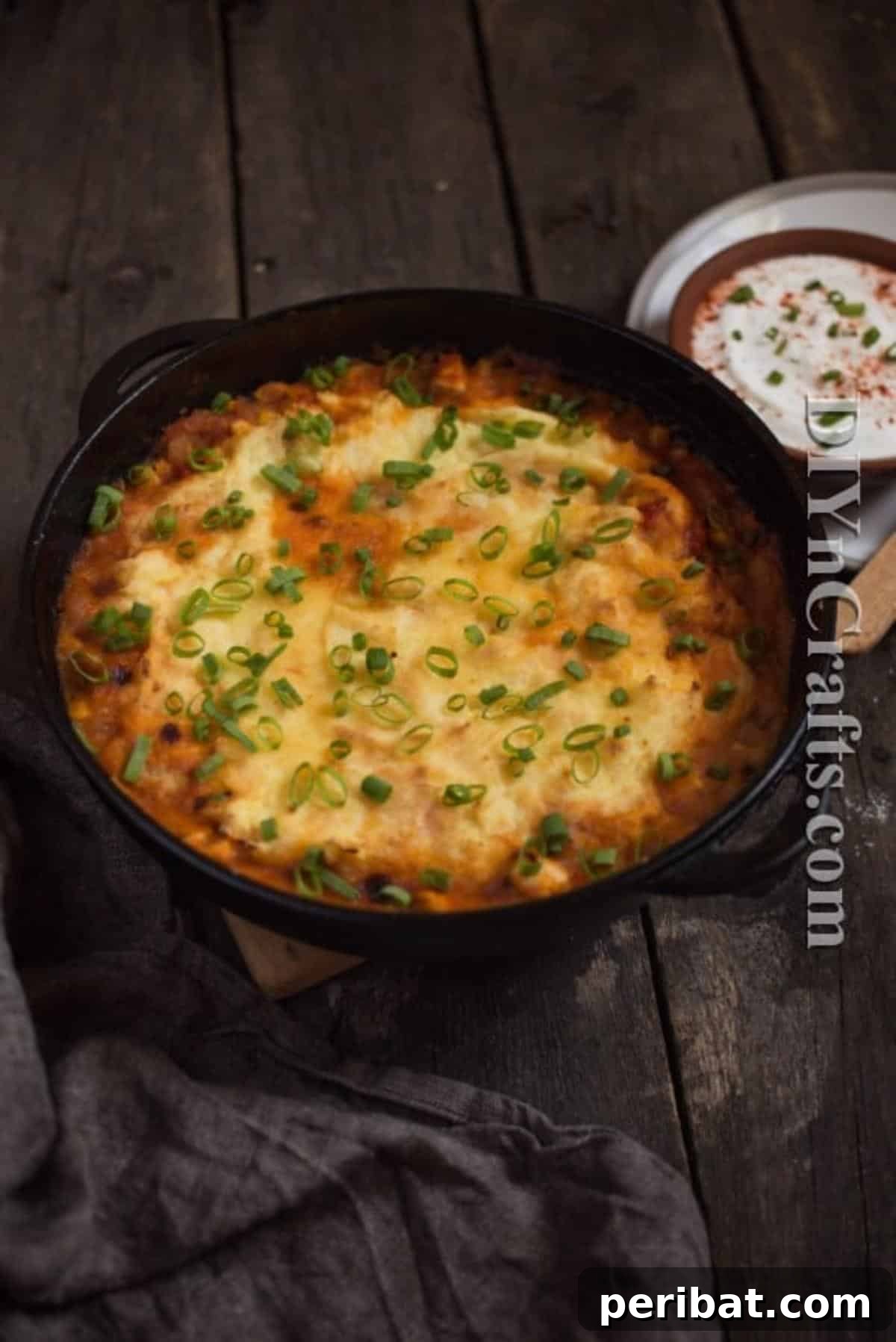 It bakes to perfection while you focus on other things! The tamale pie baking in a glass dish inside a hot oven.
