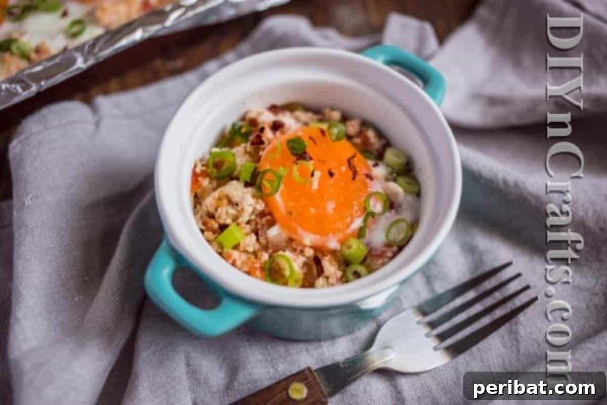 One Pan Turkey Egg Leftover Brunch 7 A serving of the baked egg and turkey dish in a white bowl, garnished with fresh herbs.