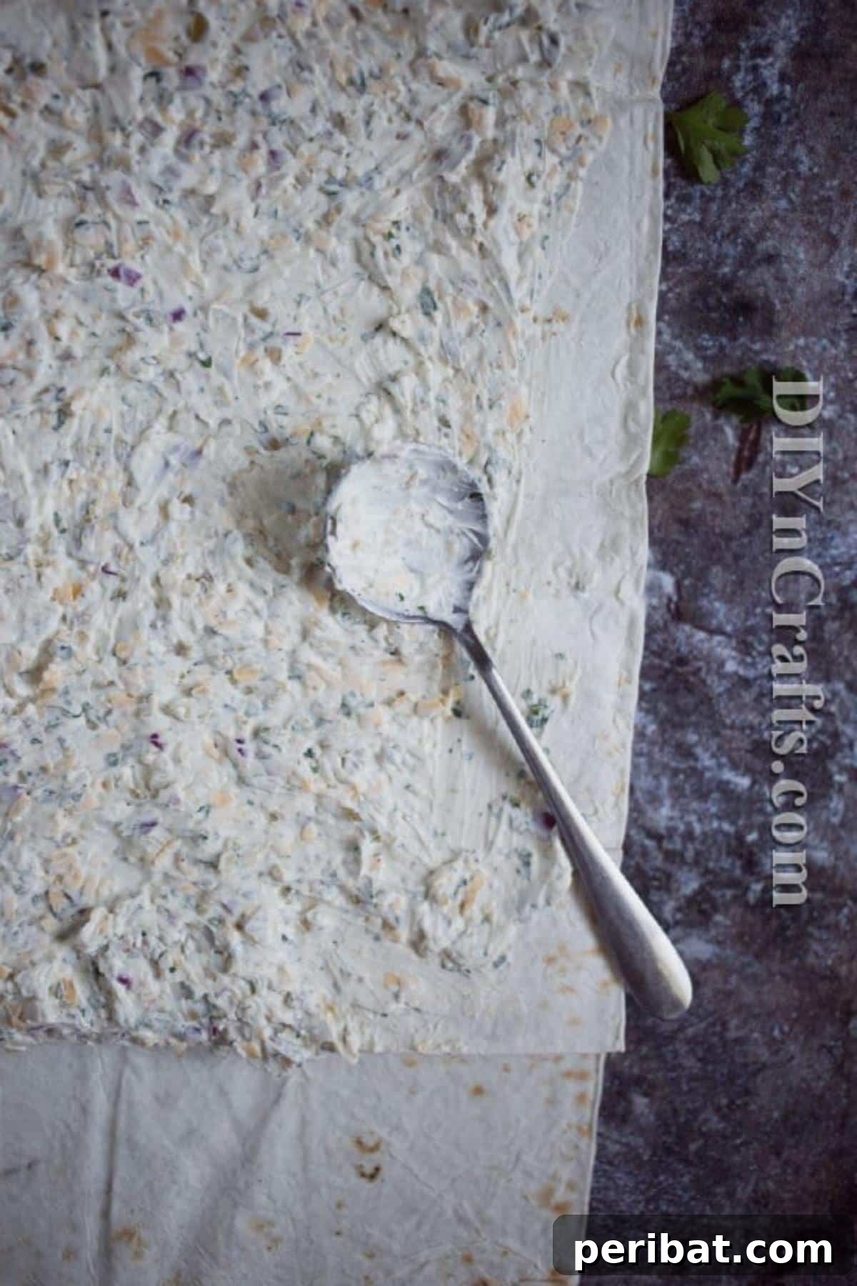 Rolling the flour tortilla with cheese filling for pinwheels