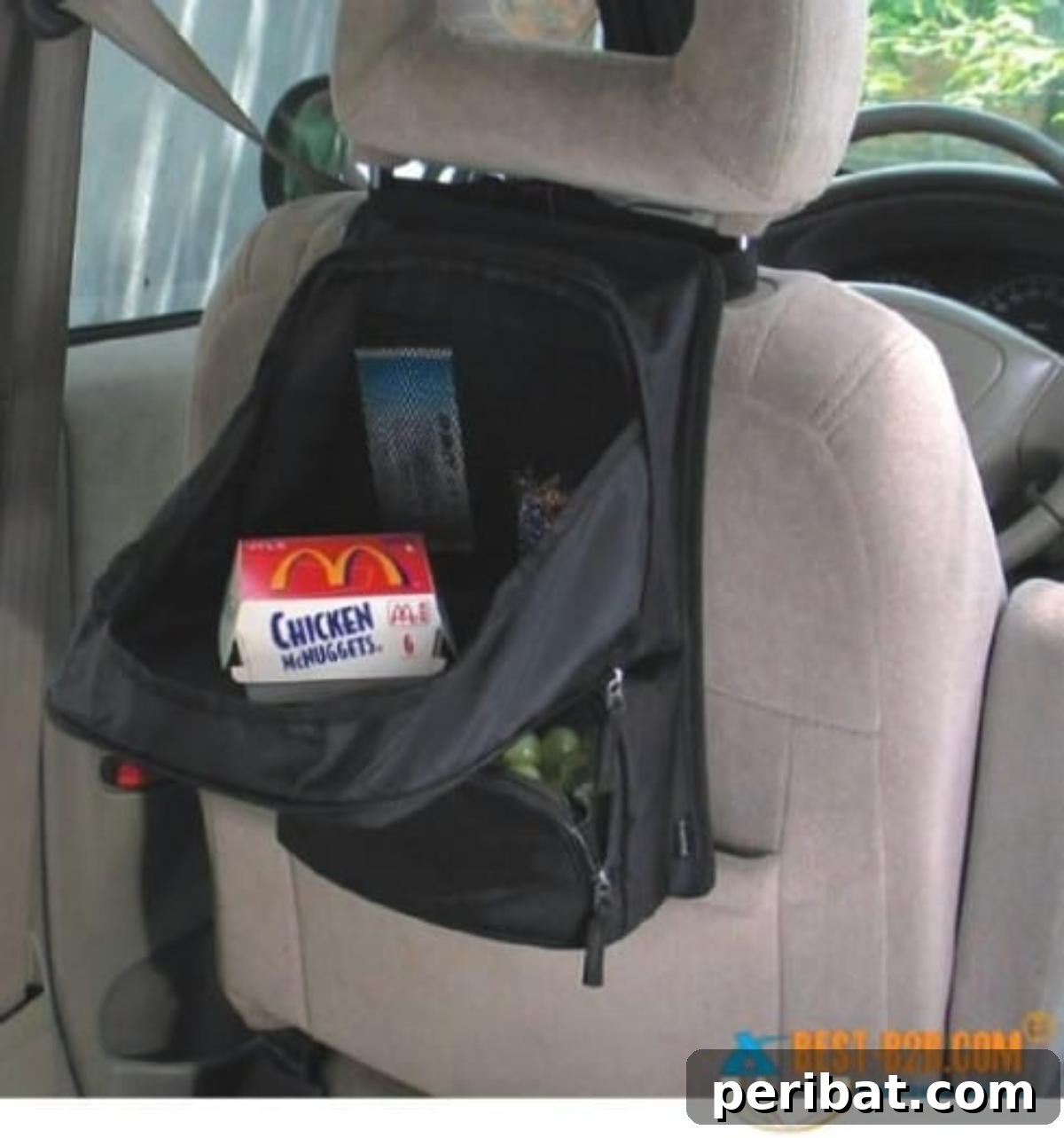 Effortless DIY Car Organization Hacks 7 A backpack creatively repurposed as a portable desk in a car, hanging on the back of the front seat and filled with art supplies and books to keep kids organized and entertained during travel.