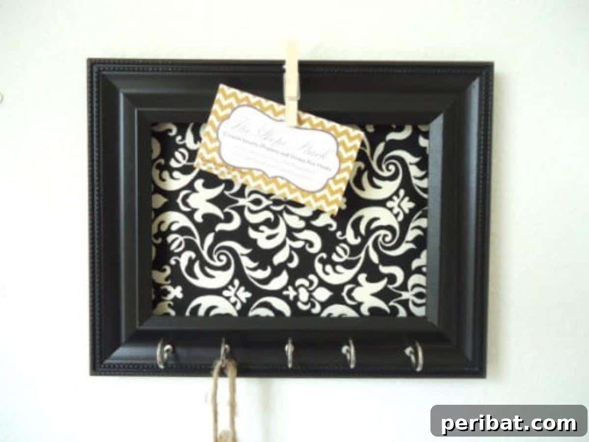 Effortless DIY Car Organization Hacks 8 A stylish DIY key organizer station featuring a framed backing, hooks for keys, and a spot for memos and emergency numbers, designed to keep household keys neatly together.