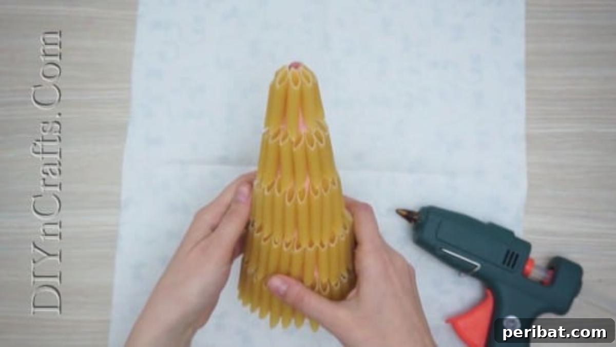 The paper cone fully covered with pasta, ready for the next step.