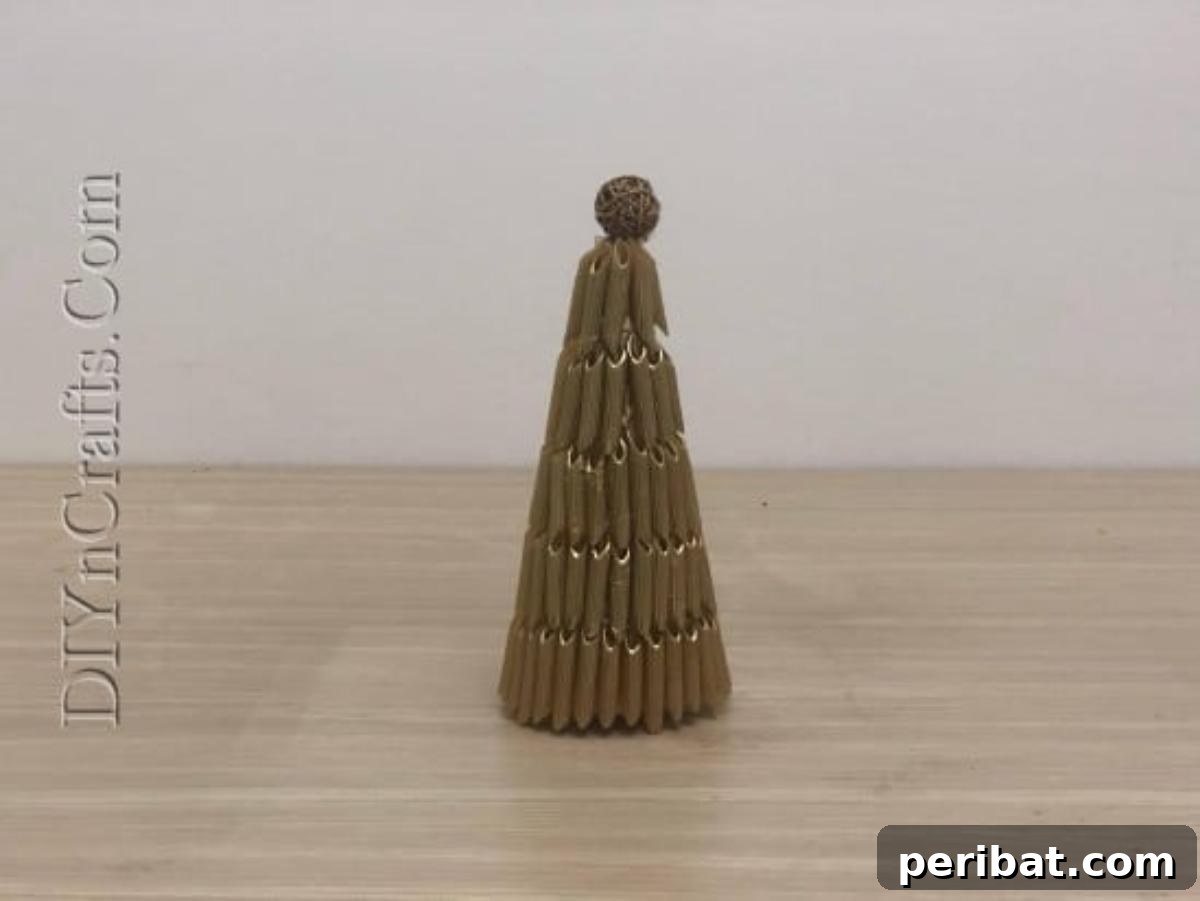 A beautifully finished and embellished pasta Christmas tree with a metallic sheen.