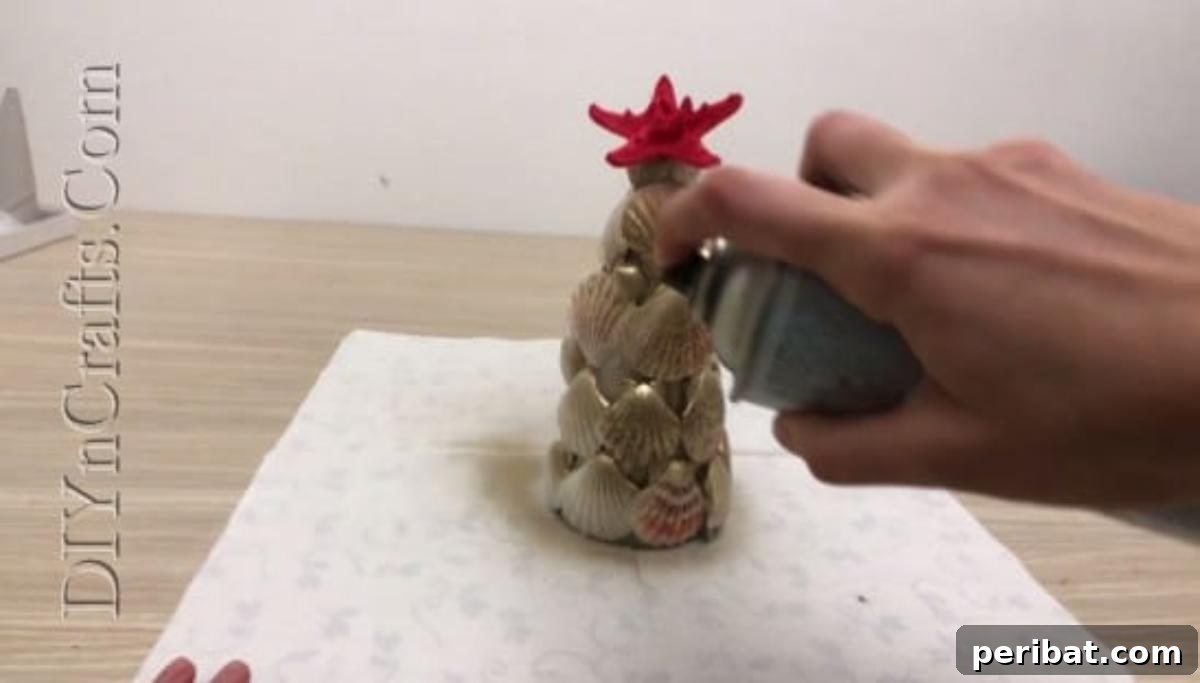 A shimmering, spray-painted shell Christmas tree, ready for display.