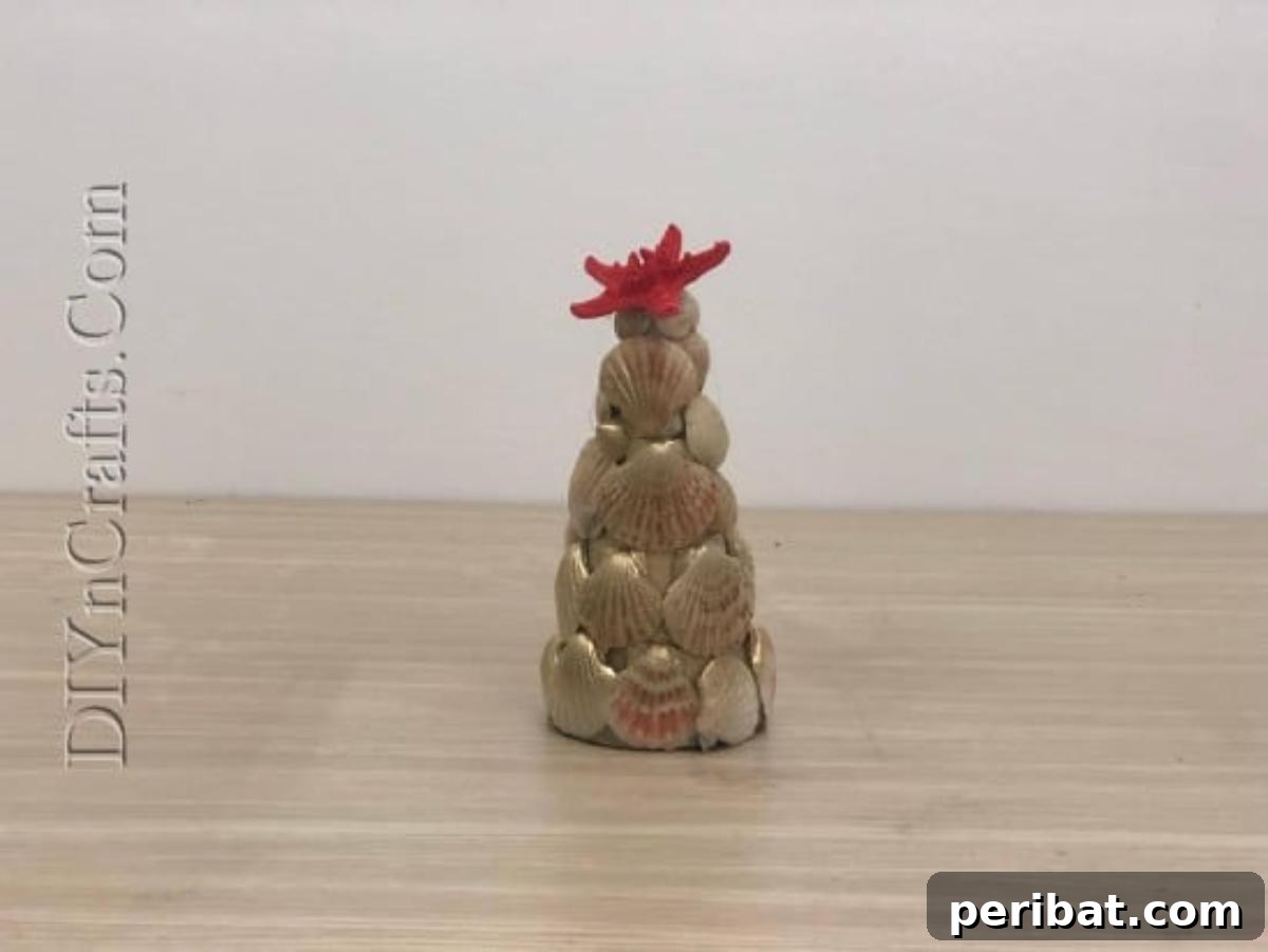 A stunning, finished shell Christmas tree with a starfish topper and metallic shine.