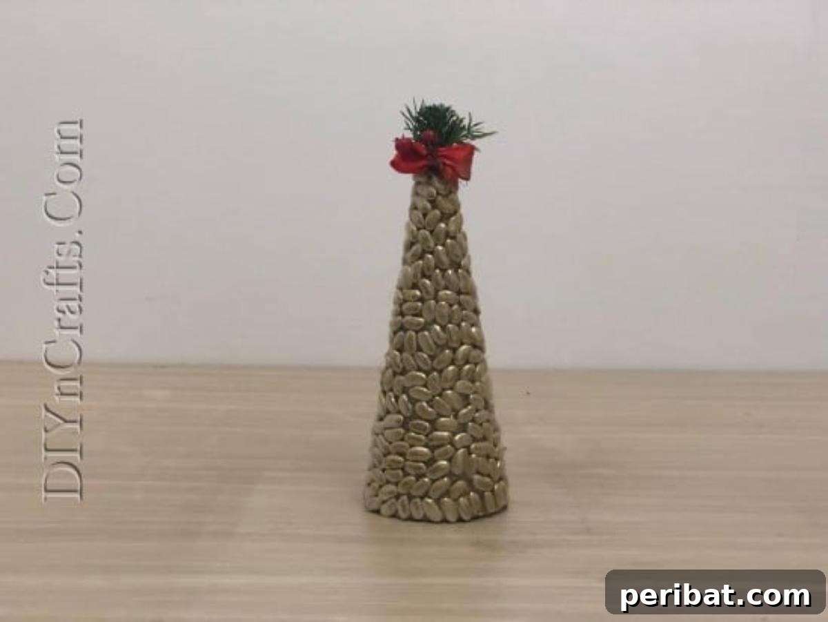 A beautifully finished and embellished bean Christmas tree with a metallic sheen.