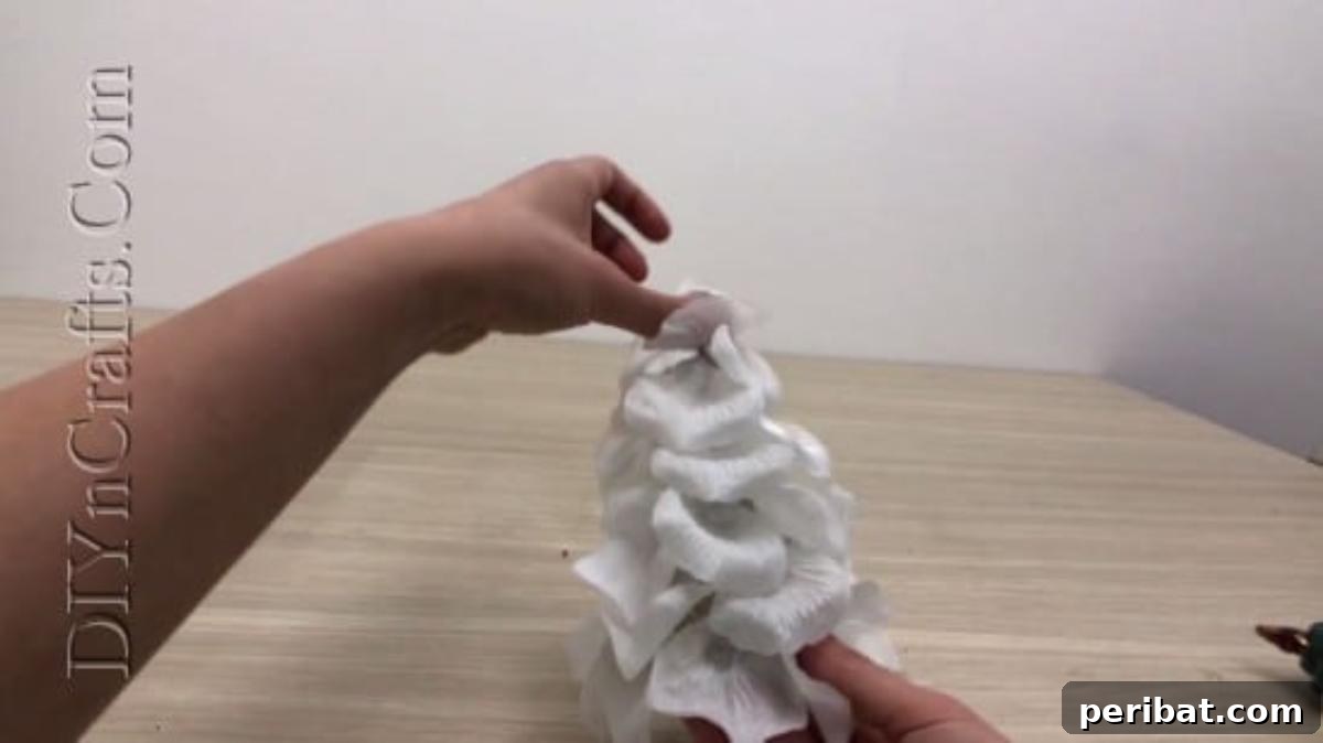 The paper cone almost entirely covered with faux flower petals for an ethereal look.