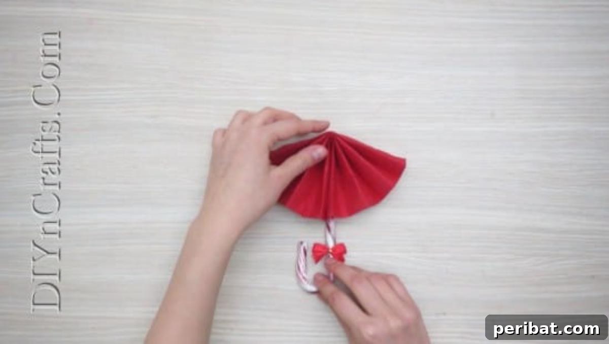 Festive Folds: 5 Simple Christmas Napkin Designs 36 Candy Cane Umbrella - How to Fold These 5 Easy and Decorative Christmas Napkins