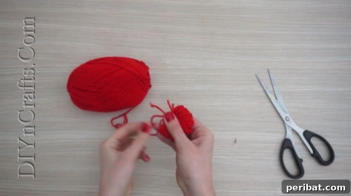 Gift Box - Yarn bundle tied in the middle, forming the core of a pom-pom for DIY Christmas crafts