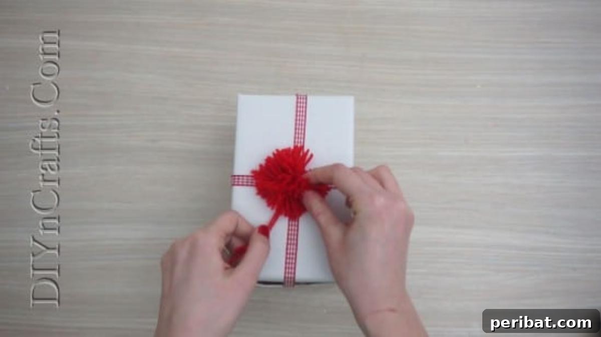 Gift Box - A wrapped present adorned with a festive ribbon, ready for a pom-pom topper