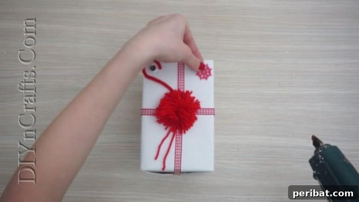 Gift Box - Another view of the embellished Christmas gift, showcasing the finished pom-pom design