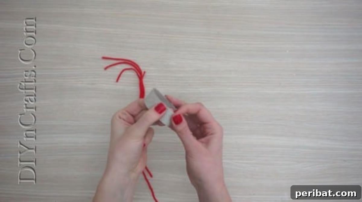 Hats - Cutting a thin slice from a paper roll for the base of a DIY Christmas yarn hat