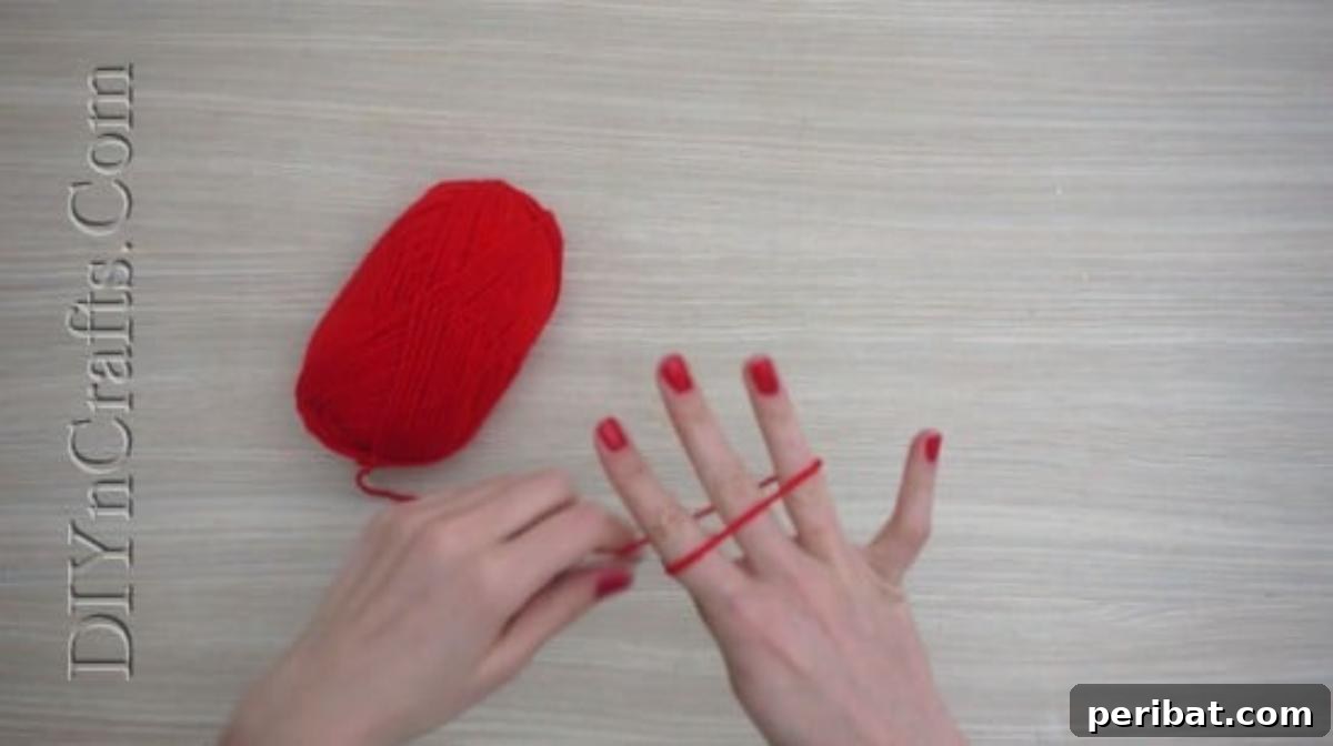 Gift Box - Wrapping yarn around fingers to create a pom-pom base for a Christmas craft