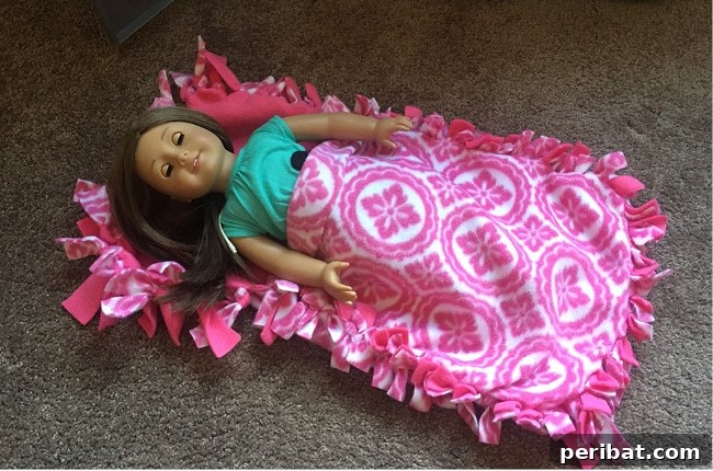 35+ Ingenious No-Sew Craft Ideas 32 American Girl doll comfortably nestled in a pink no-sew fleece sleeping bag