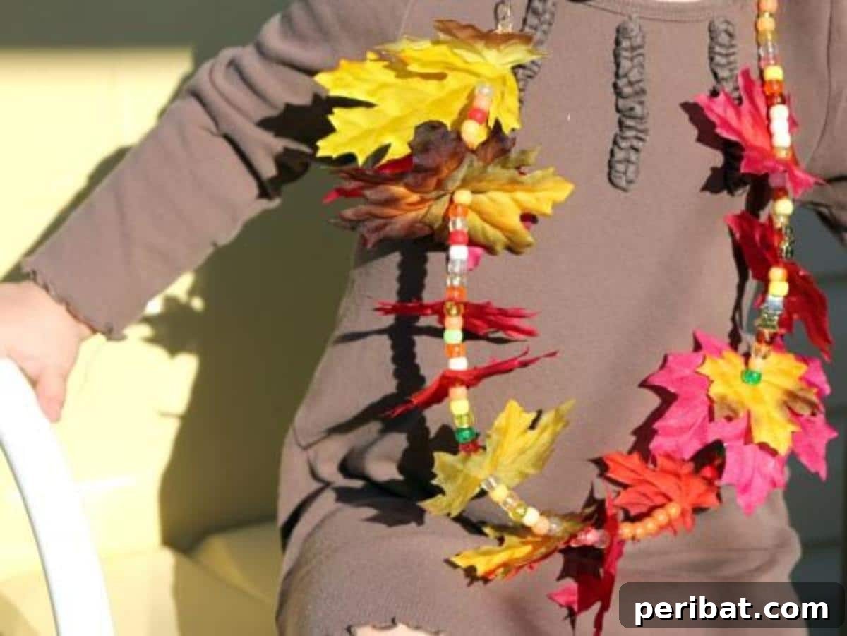 Autumn's Bounty: Creative Leaf Crafts for Young Explorers 14 Autumn Leaf Necklace, made by stringing various fall leaves together.