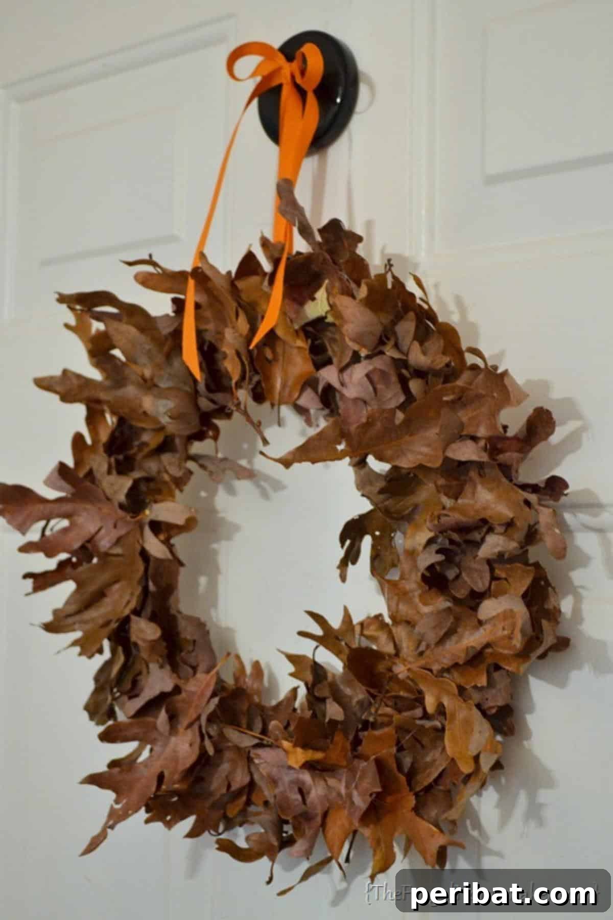Autumn's Bounty: Creative Leaf Crafts for Young Explorers 20 Autumn Leaf Wreath, made by gluing fall leaves onto a circular cardboard base.