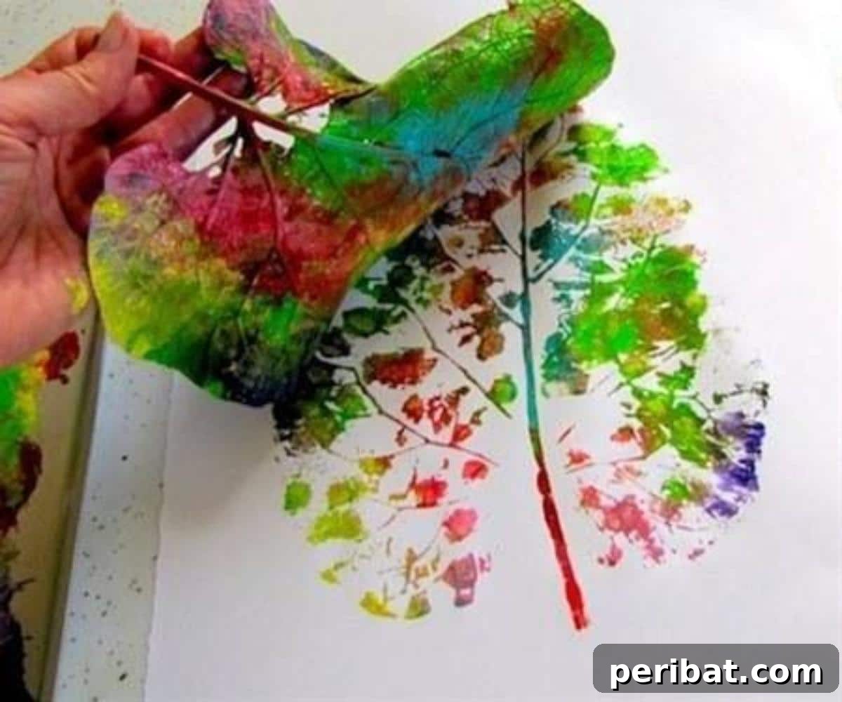 Autumn's Bounty: Creative Leaf Crafts for Young Explorers 10 Leaf Tree art made by printing painted leaves onto paper to form a tree.