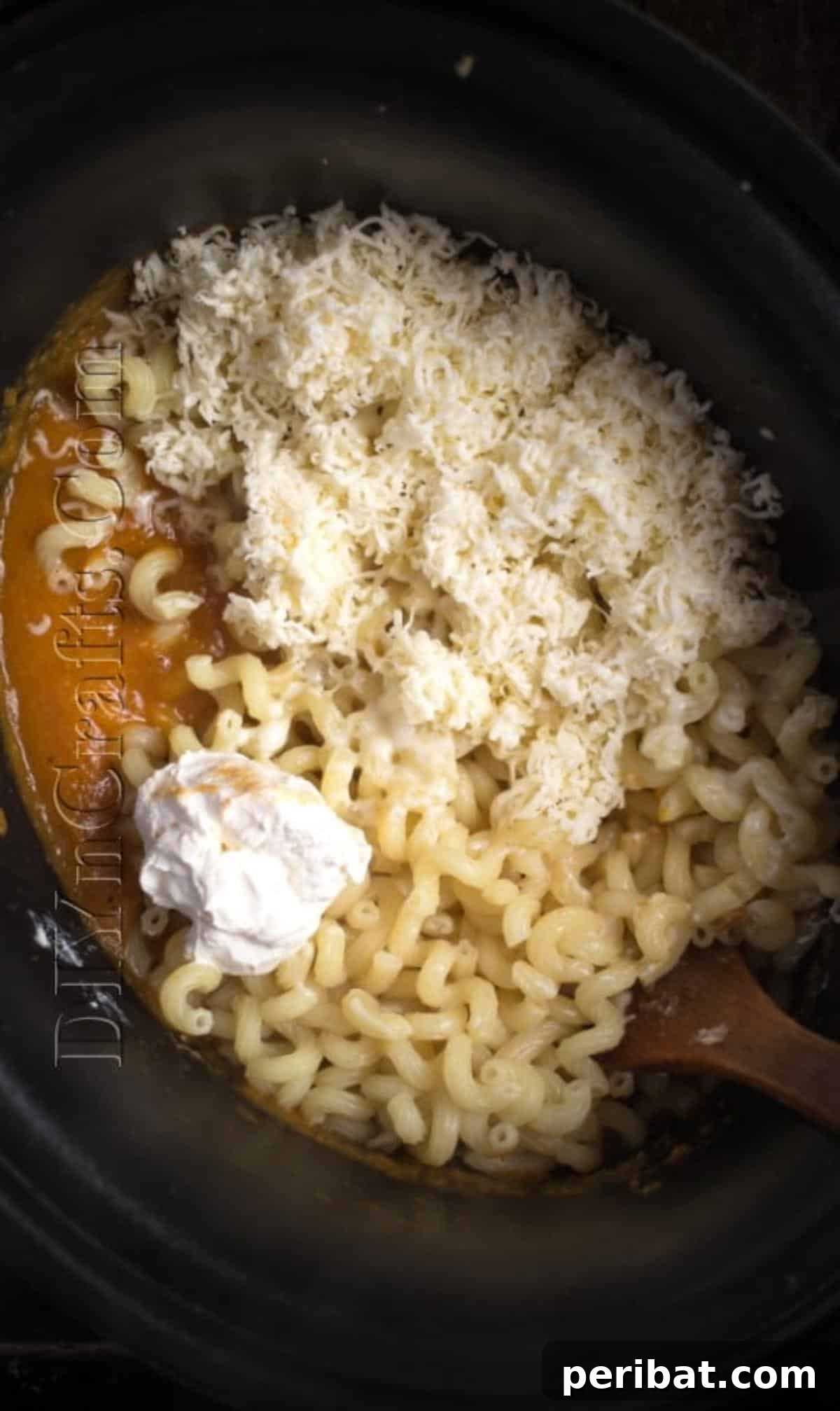 Set It and Forget It: Butternut Mac and Cheese in Your Slow Cooker 6 Mixing cooked pasta and cheeses into the blended butternut sauce in the slow cooker