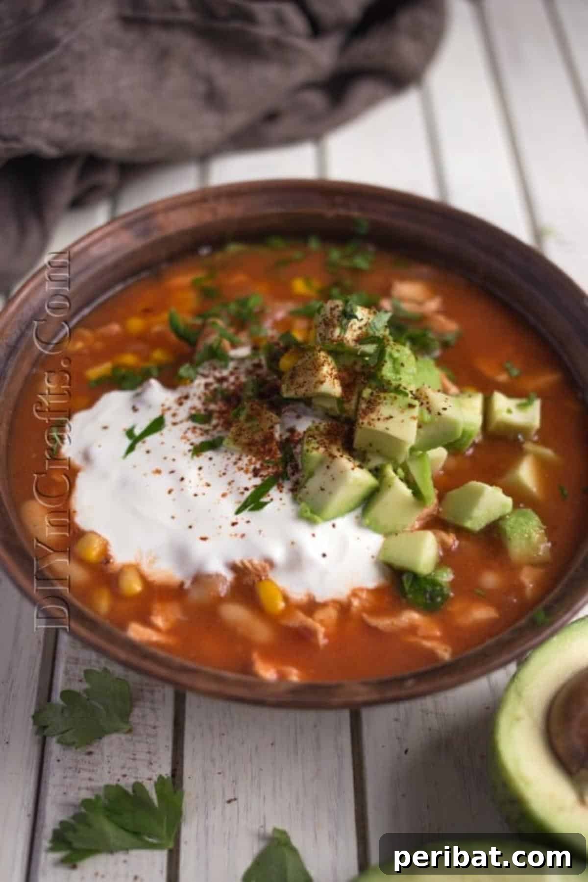 Close-up of a bowl of finished sweet tortilla soup, ready to be garnished