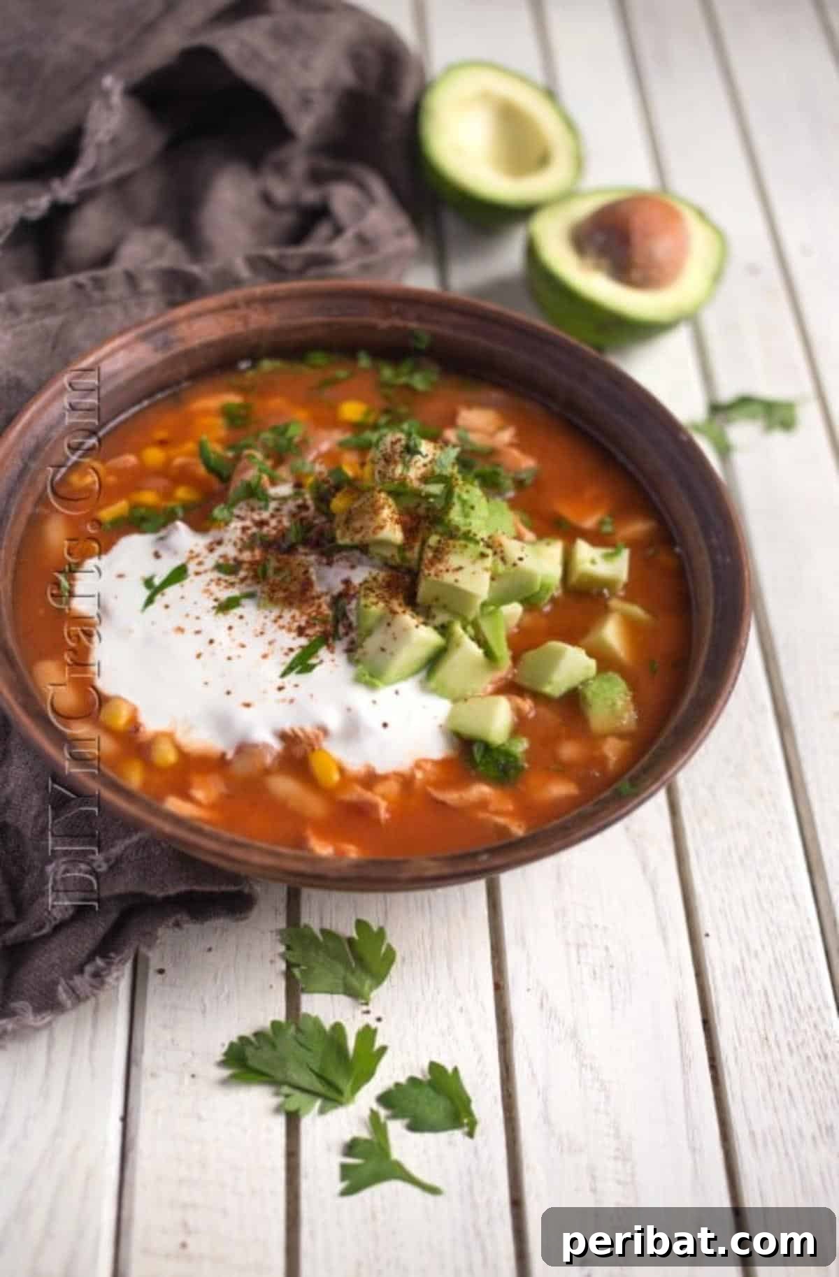 Sweet tortilla soup served in bowls, garnished with avocado and sour cream