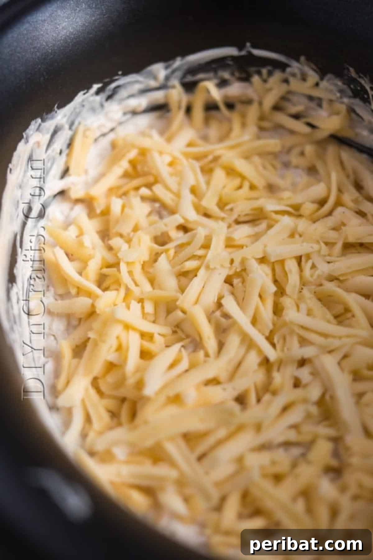 This Irresistible Cheese Dip Will Be The Star of Your Next Party 5 Adding cheddar cheese
