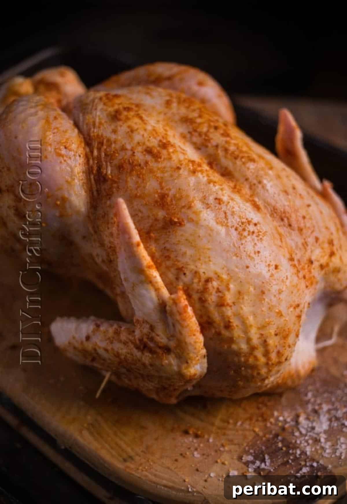 Seasoning the whole chicken generously