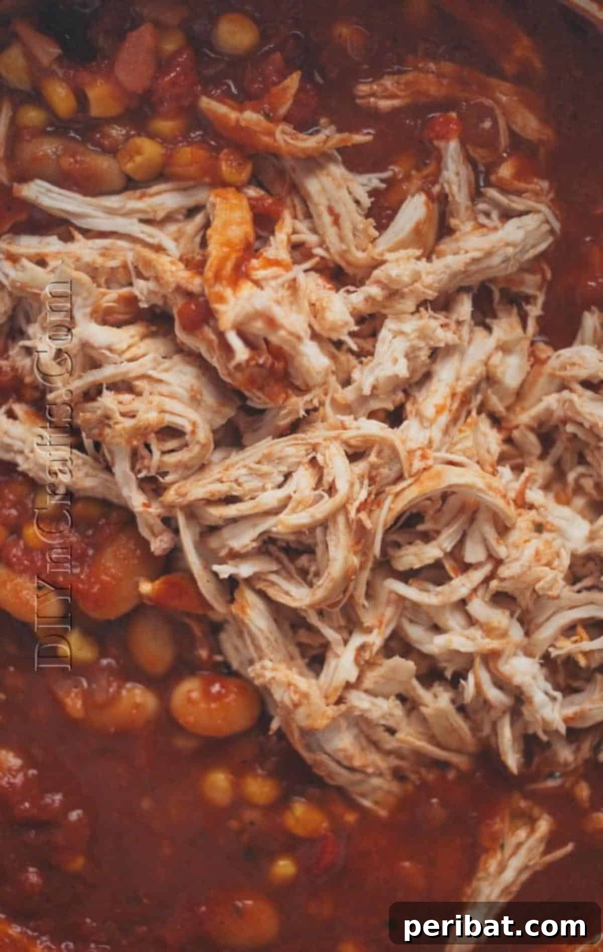Putting back the shredded chicken breasts into the slow cooker