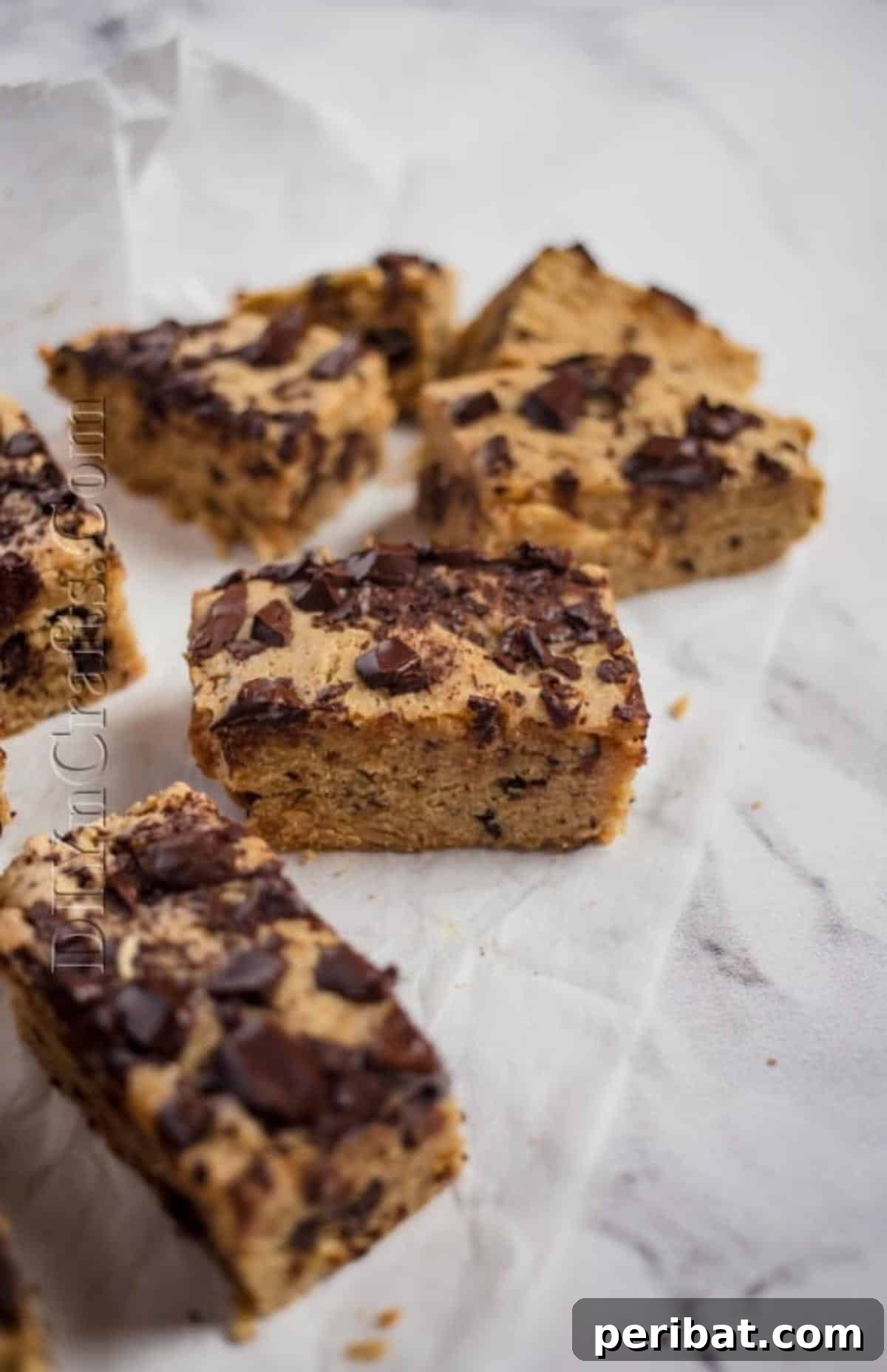 Irresistible Crock Pot Peanut Butter Chocolate Chip Bars 7 Sliced and served chocolate chip bars with powdered sugar