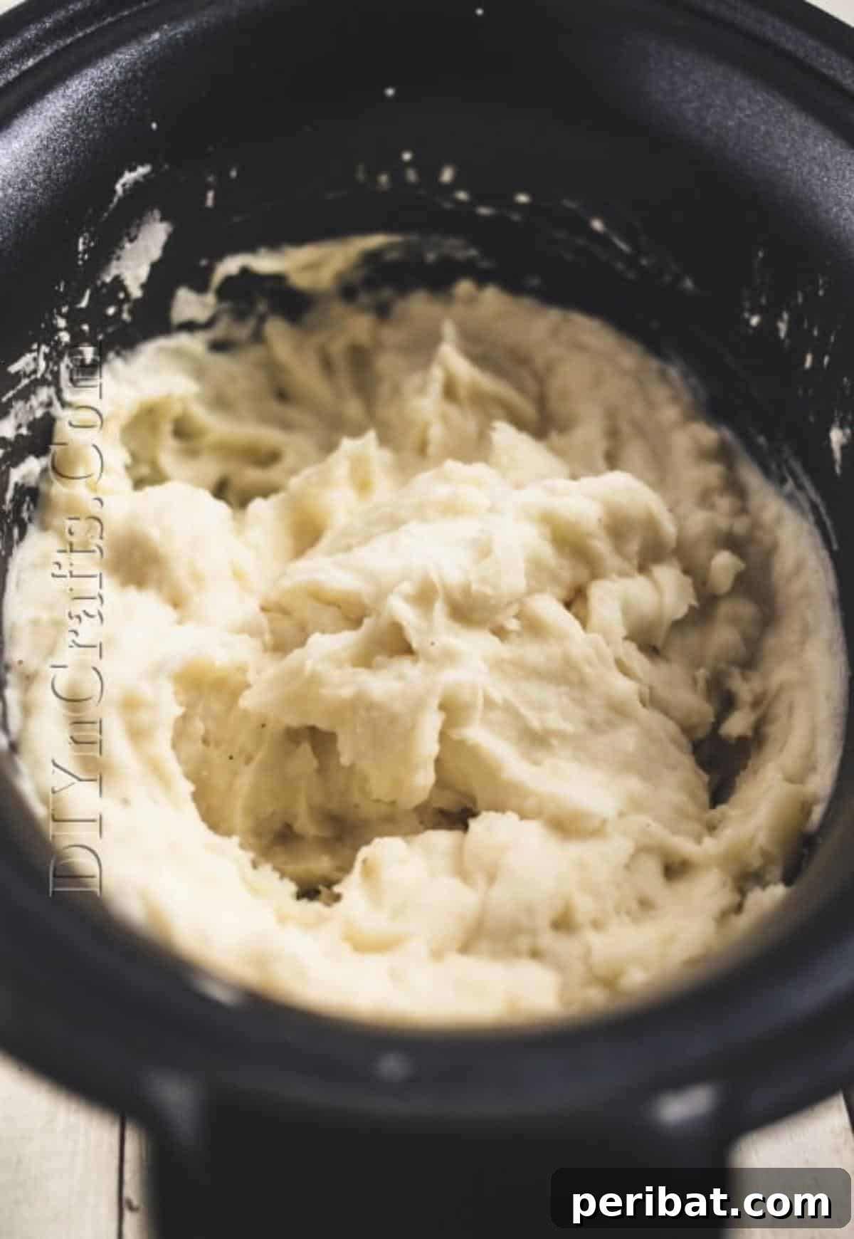 Close-up of finished, creamy mashed potatoes in a slow cooker