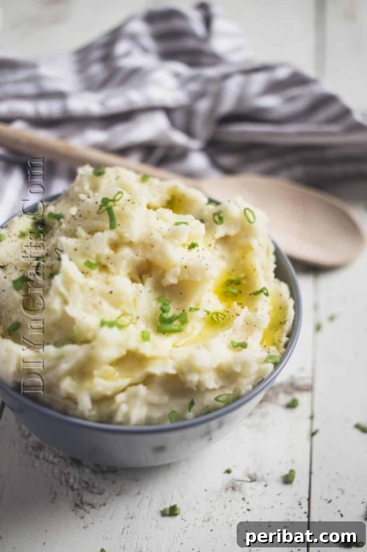 Finished slow cooker mashed potatoes served alongside a main course