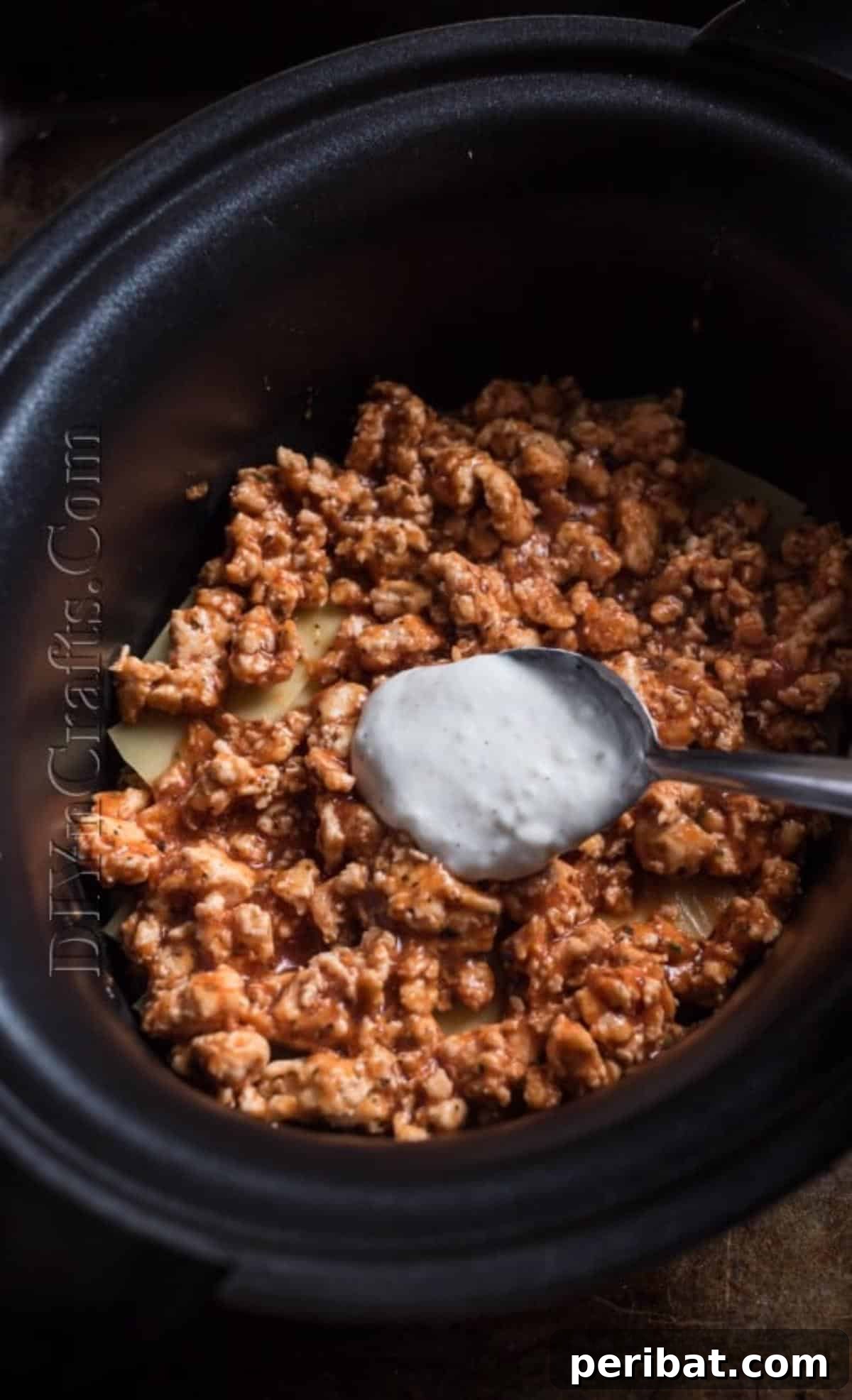 Slow Cooker Lasagna: Classic Flavor, Zero Fuss 4 Layering chicken, sauce, and cheese in a slow cooker for lasagna.