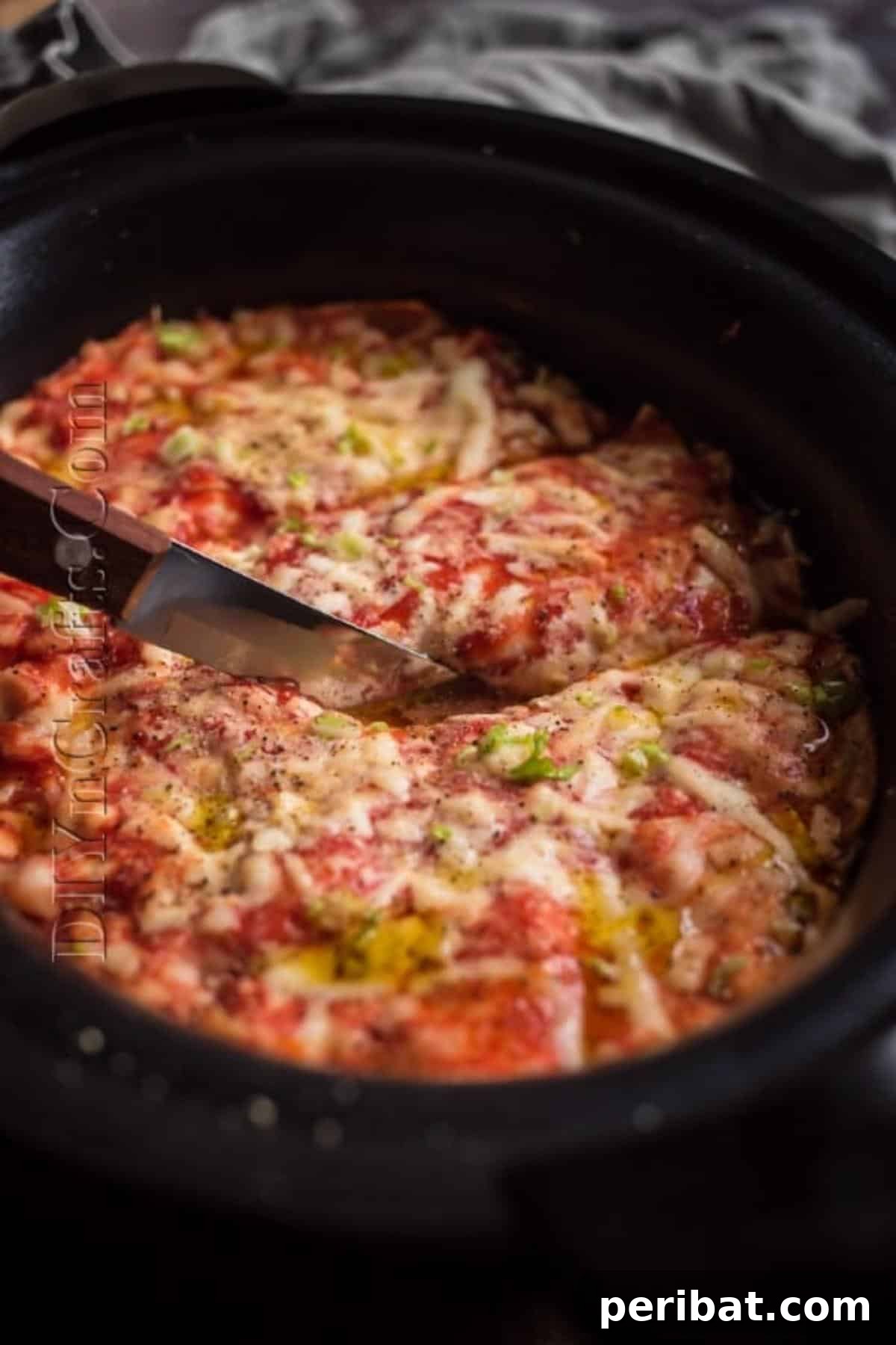 Slow Cooker Lasagna: Classic Flavor, Zero Fuss 7 Slicing a piece of slow cooker lasagna from the crockpot.