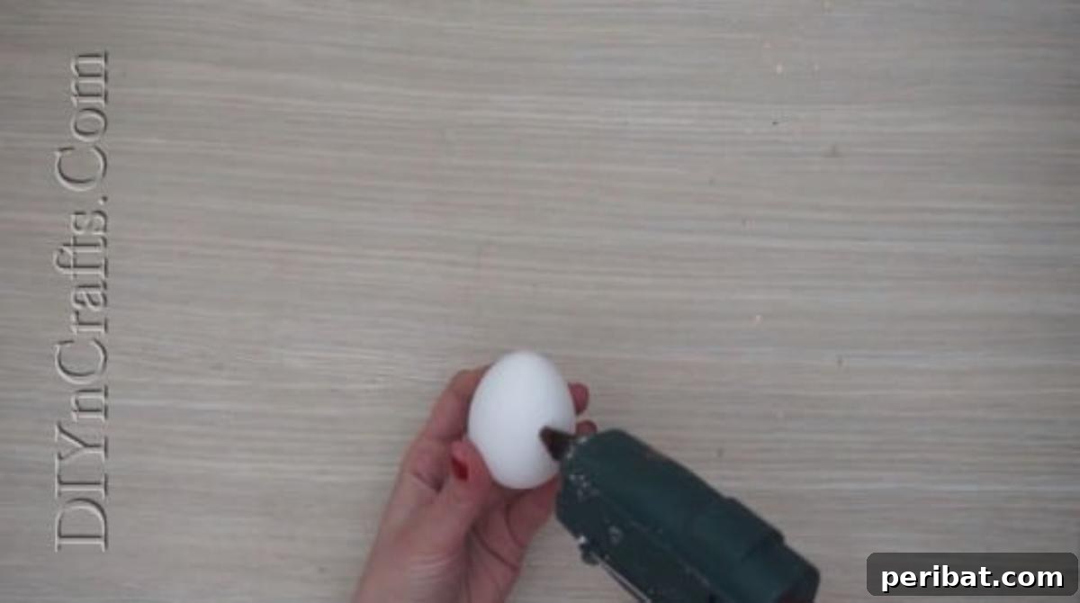 5 Brilliant & Easy Easter Egg Projects 15 Step 1: Attaching googly eyes to the upper part of an egg with hot glue, giving it an immediate spark of personality and charm.