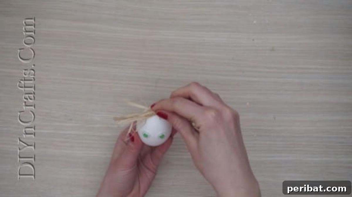 5 Brilliant & Easy Easter Egg Projects 17 Step 2: Hot-gluing a bunch of straw to the top of the egg, creating a charming and textured 'hair' style for the character egg.