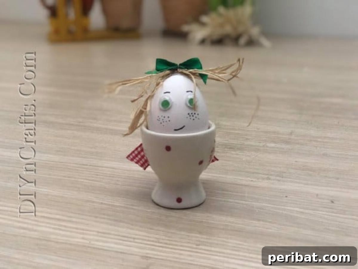 5 Brilliant & Easy Easter Egg Projects 19 Step 4: The completed Egg with Straw Hair, featuring drawn facial features and a bow, displayed in a cup, full of whimsical charm and character.
