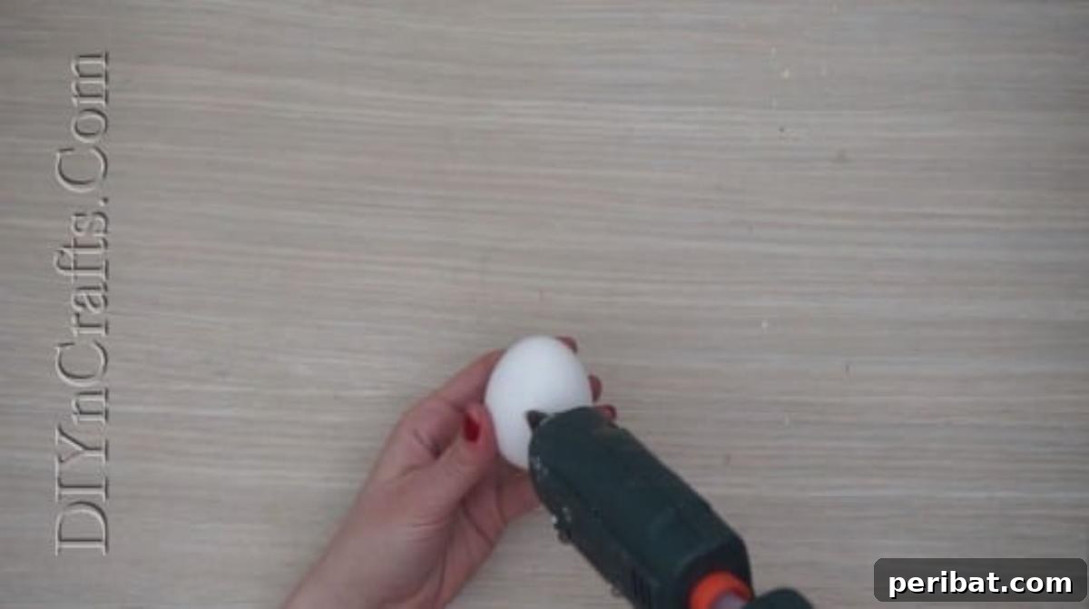 5 Brilliant & Easy Easter Egg Projects 20 Step 1: Attaching two googly eyes to an egg with hot glue, preparing the base for a comical and surprised facial expression.