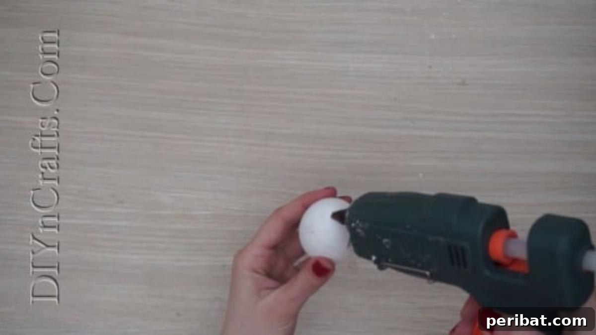5 Brilliant & Easy Easter Egg Projects 3 Step 1: Attaching a fluffy cotton topping to an egg with hot glue to create the base for a whimsical ice cream cone design.
