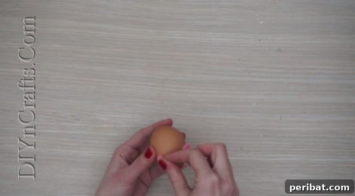 5 Delightful & Simple Easter Egg Crafts 14 Attaching the felt ears and curly tail to the pig egg with hot glue.