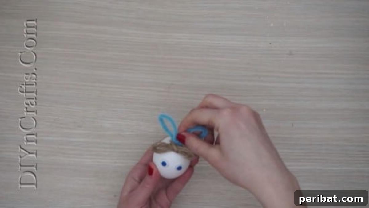 5 Delightful & Simple Easter Egg Crafts 20 Attaching bent pipe cleaners, shaped as bunny ears, to the top of the Easter egg using hot glue.