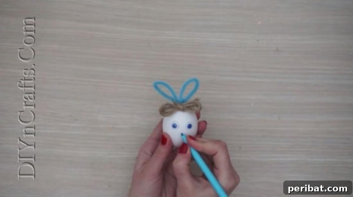 5 Delightful & Simple Easter Egg Crafts 21 Drawing bunny features like a nose and mouth on the Easter egg with a marker, completing the face.
