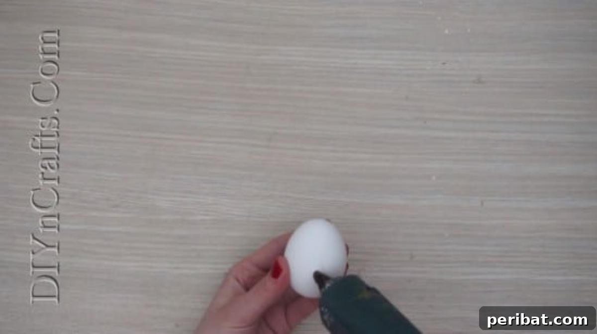 5 Delightful & Simple Easter Egg Crafts 23 Applying hot glue to the rim of a colorful plastic bottle cap.