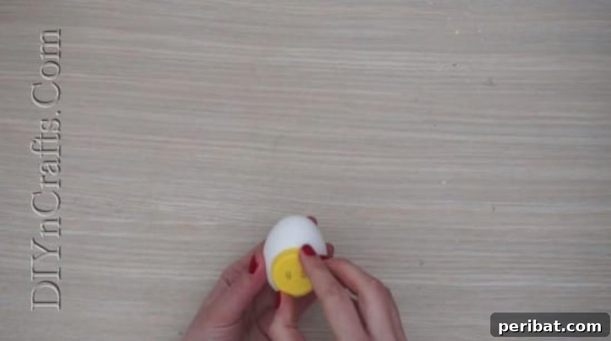 5 Delightful & Simple Easter Egg Crafts 24 Pressing the glued plastic bottle cap onto the center of an Easter egg to form the snorkeling mask.