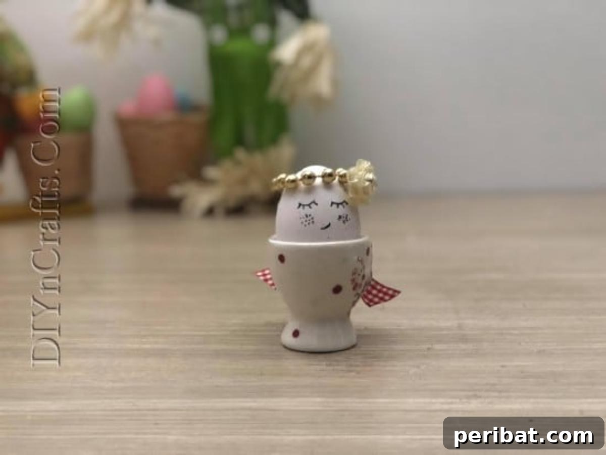 5 Delightful & Simple Easter Egg Crafts 6 A finished 'Pretty Egg' with a hand-drawn face and beaded crown, proudly displayed in an egg cup.