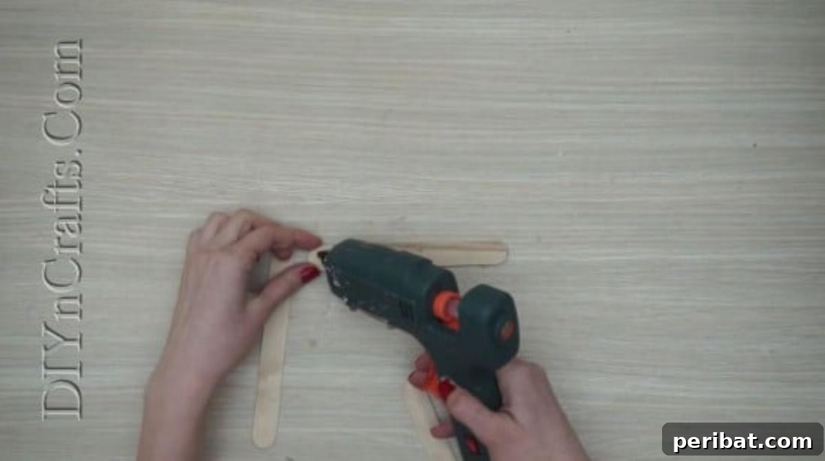 Craft Stick Easter Magic: 5 Simple DIY Projects 2 Gluing three craft sticks into a triangle for an Easter bunny's head