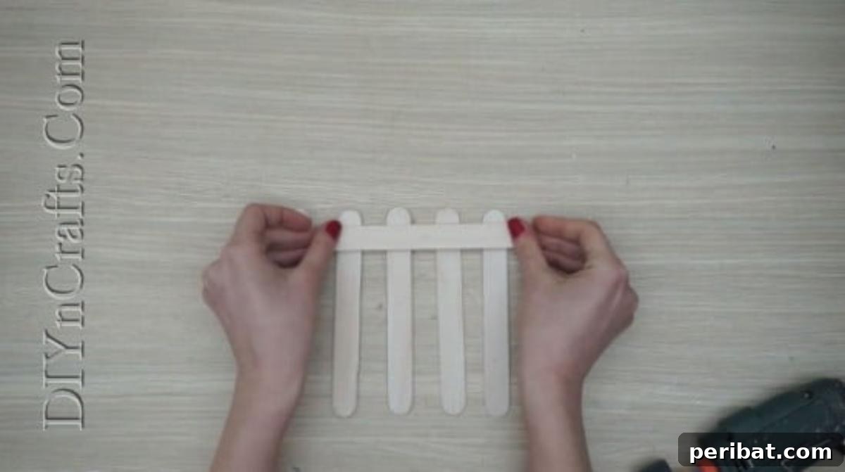 Craft Stick Easter Magic: 5 Simple DIY Projects 11 Attaching the top horizontal craft stick to form the fence structure